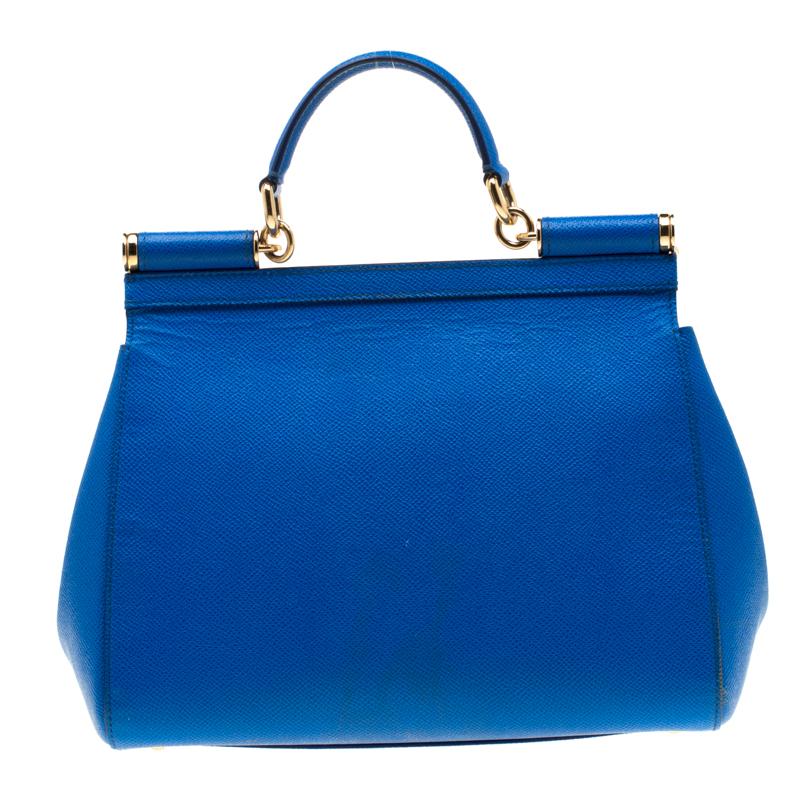 This gorgeous blue Miss Sicily bag from Dolce and Gabbana is a handbag coveted by women around the world. It has a well-structured design and a flap that opens to a compartment with fabric lining and enough space to fit your essentials. The bag