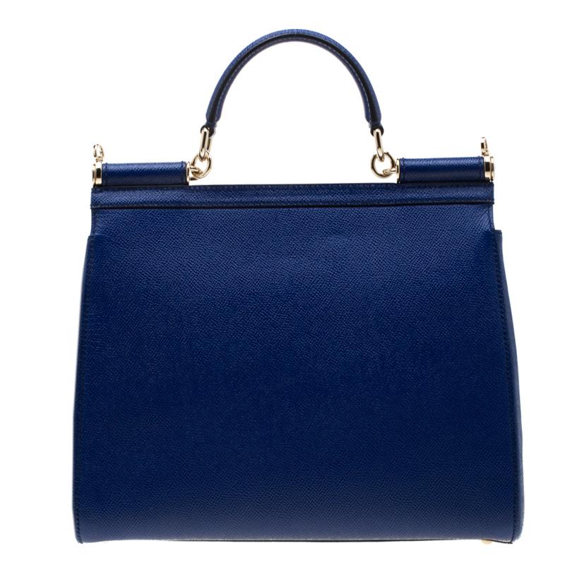 This gorgeous blue Miss Sicily tote from Dolce & Gabbana is a handbag coveted by women around the world. It has a well-structured design and a flap that opens to a compartment with fabric lining and enough space to fit your essentials. The bag comes