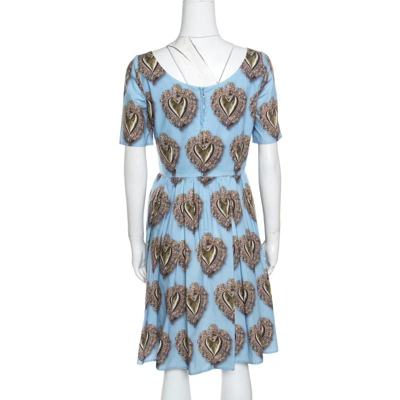 You'll amaze the crowds and win praises from one and all when you step out in this gorgeous blue dress from Dolce and Gabbana. It is made of 100% cotton and features sacred hearts printed all over it. It flaunts a bateau neckline, short sleeves and