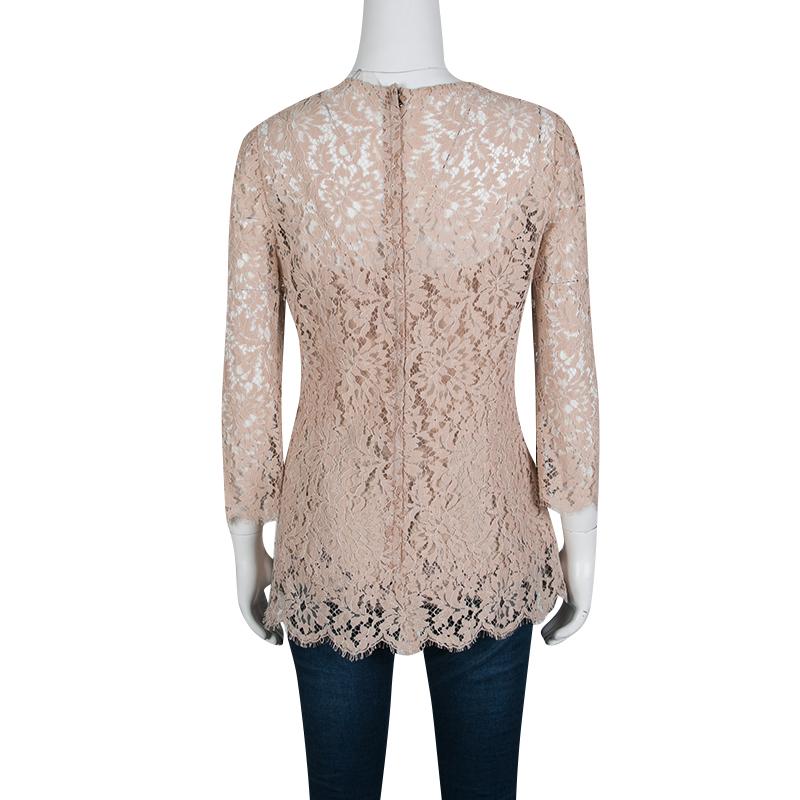 Dolce and Gabbana's blushed pink blouse echoes romantic aesthetics and a chic appeal. It is crafted with a cotton nylon blend and glorified with floral lace overlay and scalloped hem. Lightweight and comfortable, it features long sleeves and zip