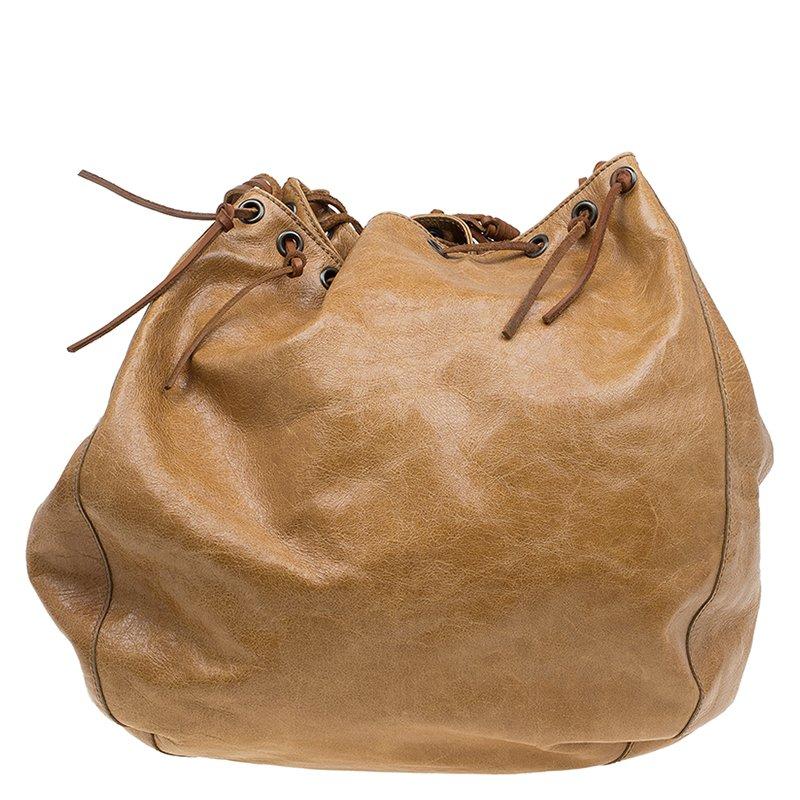 Dolce & Gabbana’s bucket hobo bag is brimming with bohemian-inspired glamour. Made from distressed brown leather, it features a drawstring fastening and tasselled shoulder strap with a brass ring detail. This practical yet stylish carryall is