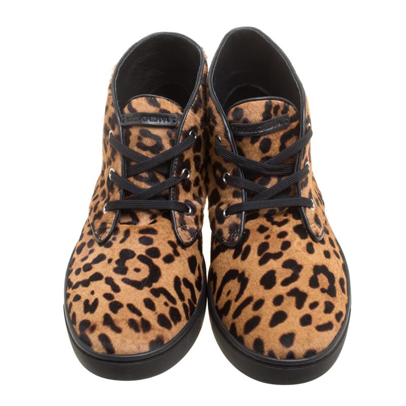 Chic and stylish, these high top sneakers from Dolce and Gabbana are a must buy! The brown sneakers are crafted from calf hair and leather and feature a leopard printed pattern all over the exterior. They flaunt round toes, lace-ups on the vamps and