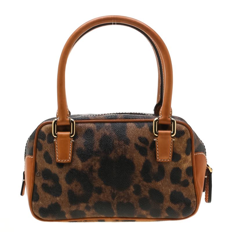 Swing this Dolce & Gabbana satchel for your daily errands or sprees. The leopard print bag is crafted from coated canvas and enhanced with leather trims. The zip top closure opens to a canvas lined interior. The bag is completed with dual