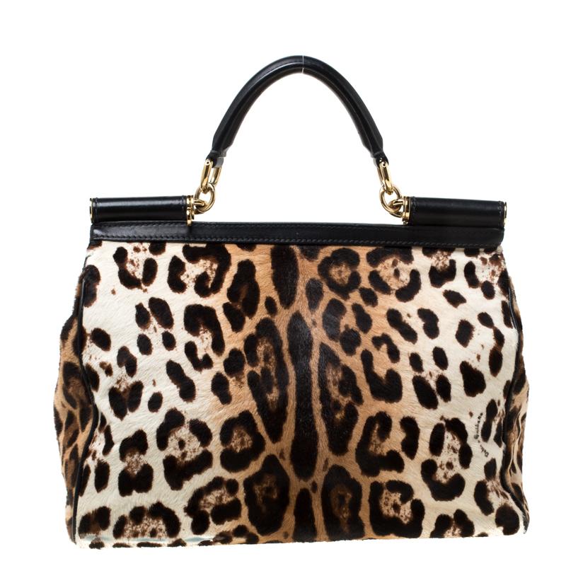 This gorgeous leopard printed Miss Sicily bag from Dolce & Gabbana is a handbag coveted by women around the world. It has a well-structured design crafted from exotic calf hair and trimmed with leather. The front flap opens to a compartment with