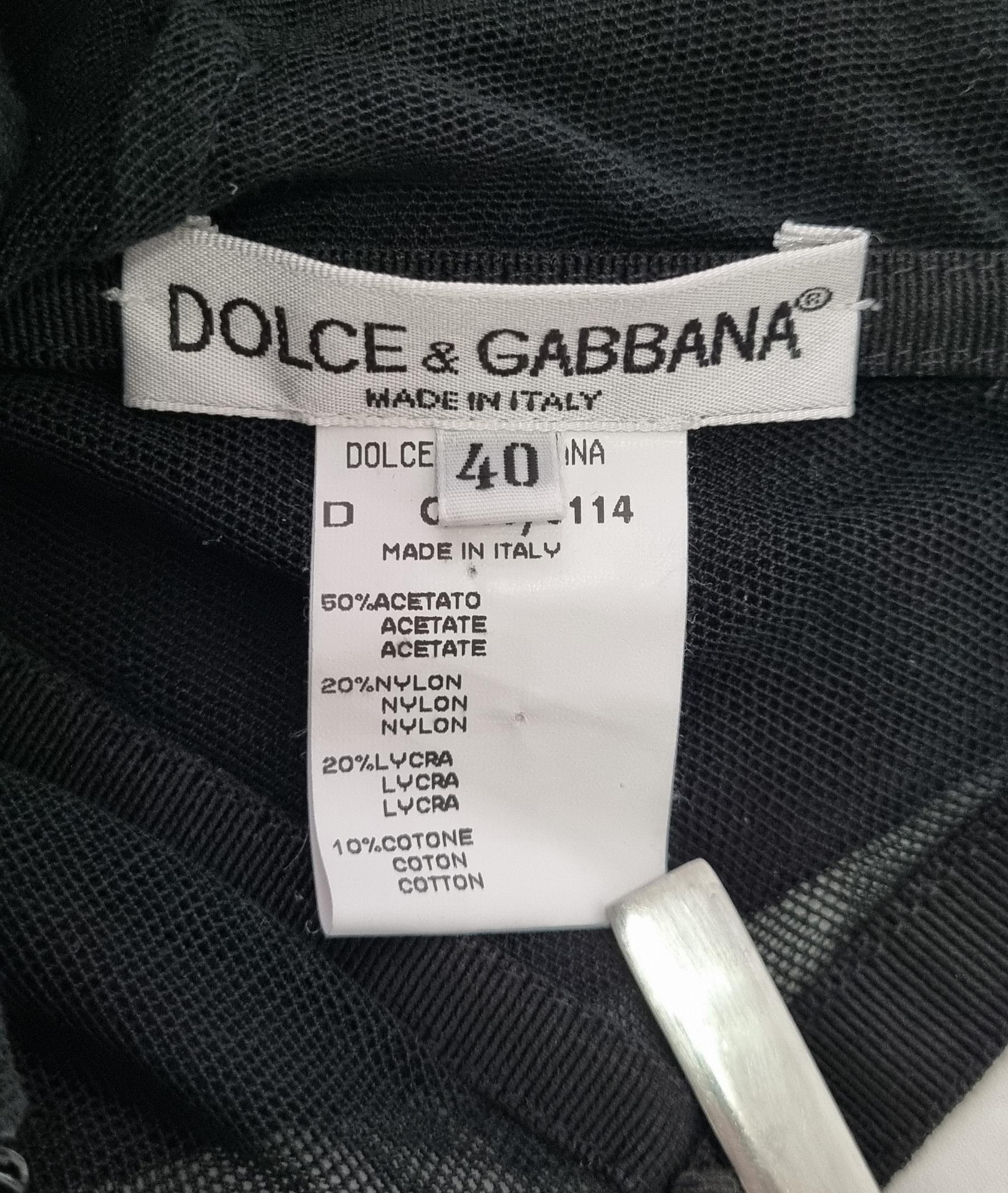 Inbuilt corseted dress from Dolce and Gabbanas iconic 'Stromboli collection' with a butterfly applique.

Size: Italian 40. Fits like a XS to S

Material: Acetate, Nylon, lycra and cotton 

Condition: Very Good