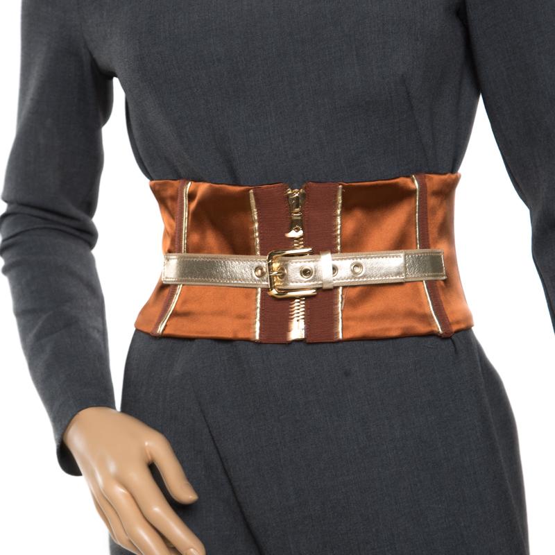 Dolce and Gabbana's take on fashion is anything but generic. Corset belts have made a stimulating comeback in a tweaked fashion. This one is crafted from a blend of fabrics and features a zipper and a buckled belt to the front along with tie-detail