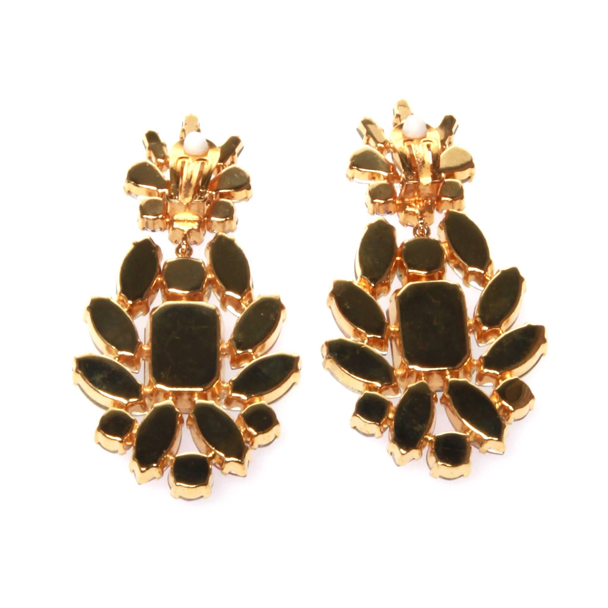 Dolce and Gabbana clip on earrings featuring a cluster of multi-coloured cut glass stones. Set in matte gold-tone metal. 
Comes with authentic and original box.