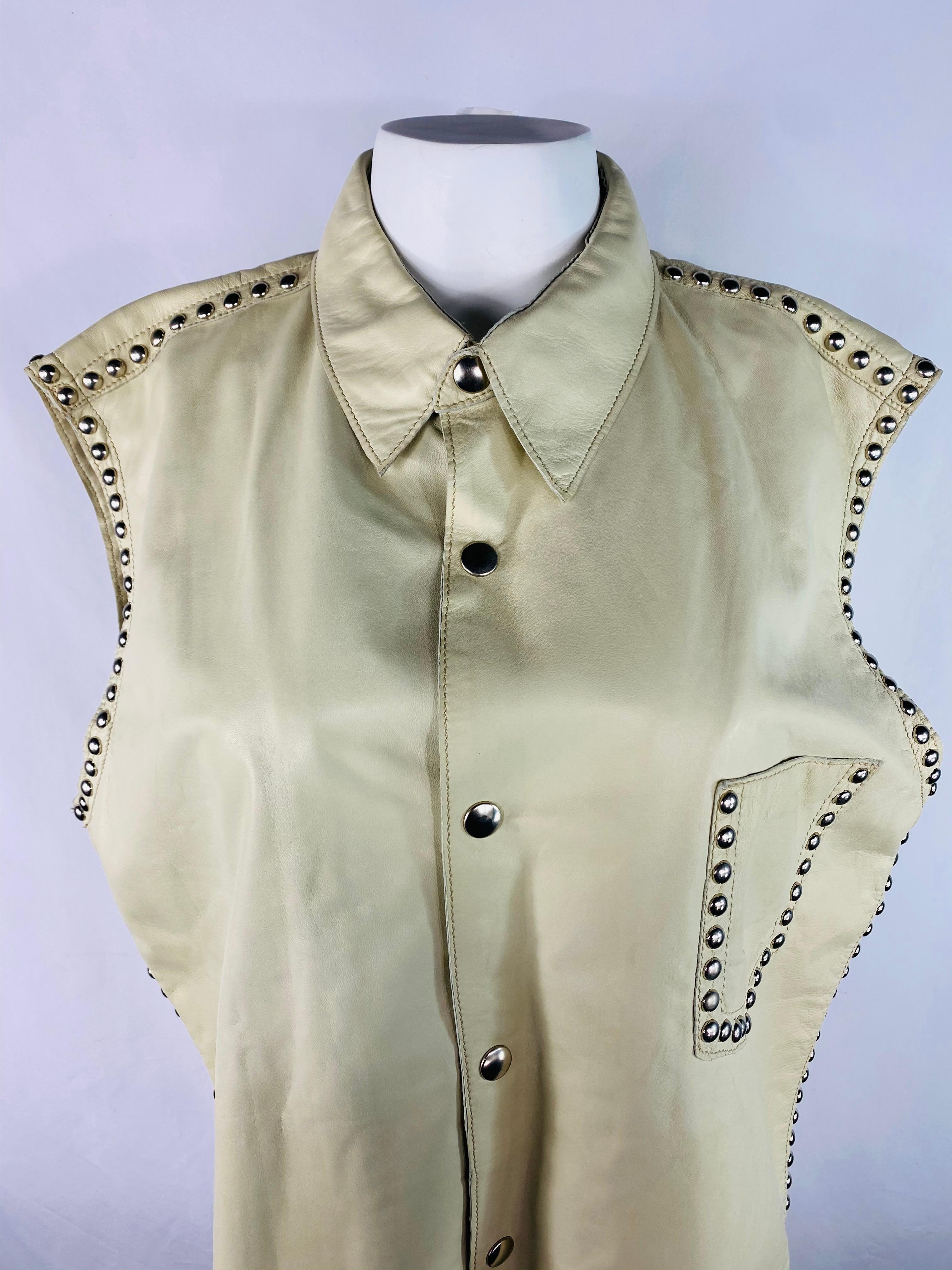 Product details;

Featuring cream/ ivory 100% leather with silver tone hardware details throughout, font button down closure, side pocket and collar. Made in Italy.