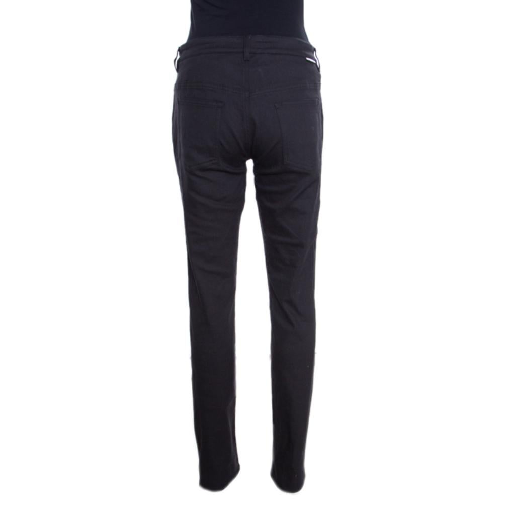 You are instantly going to love these straight fit jeans from Dolce and Gabbana. They are made of a cotton blend flaunting a classic black hue along with buttoned front fastenings and multiple external pockets. Team them up with contrasting polo