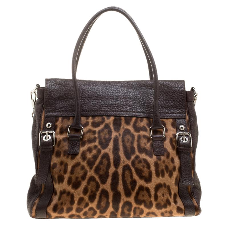 This Dolce&Gabbana bag is not only visually magnificent but also functional. It has been crafted from dark brown leather, leopard-printed calf hair and styled into a shape that is classy and posh. The bag has two top handles and a flap that reveals