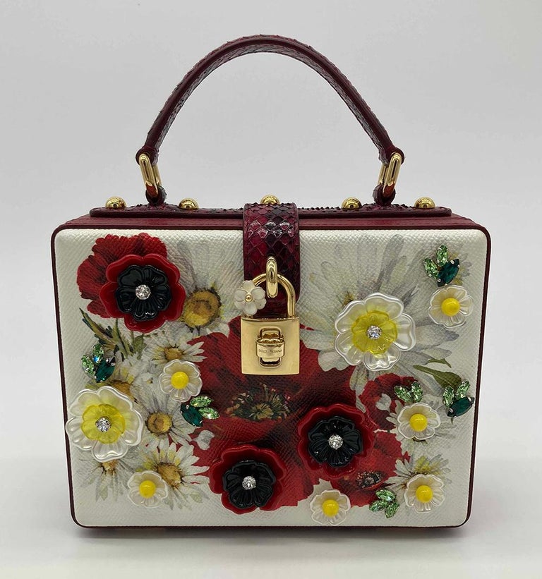 Dolce and Gabbana Dauphine Box Bag in NWOT condition. Red and white grained leather with red poppy and white daisy floral print and crystal embroidered resin flowers. Gold hardware. Matching removable shoulder strap. Twist lock front closure opens