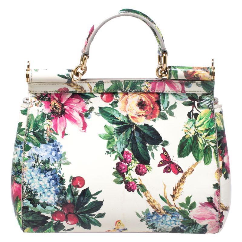 This gorgeous floral printed Miss Sicily satchel from Dolce & Gabbana is a handbag coveted by women around the world. It has a well-structured design and a flap that opens to a compartment with fabric lining and enough space to fit your essentials.