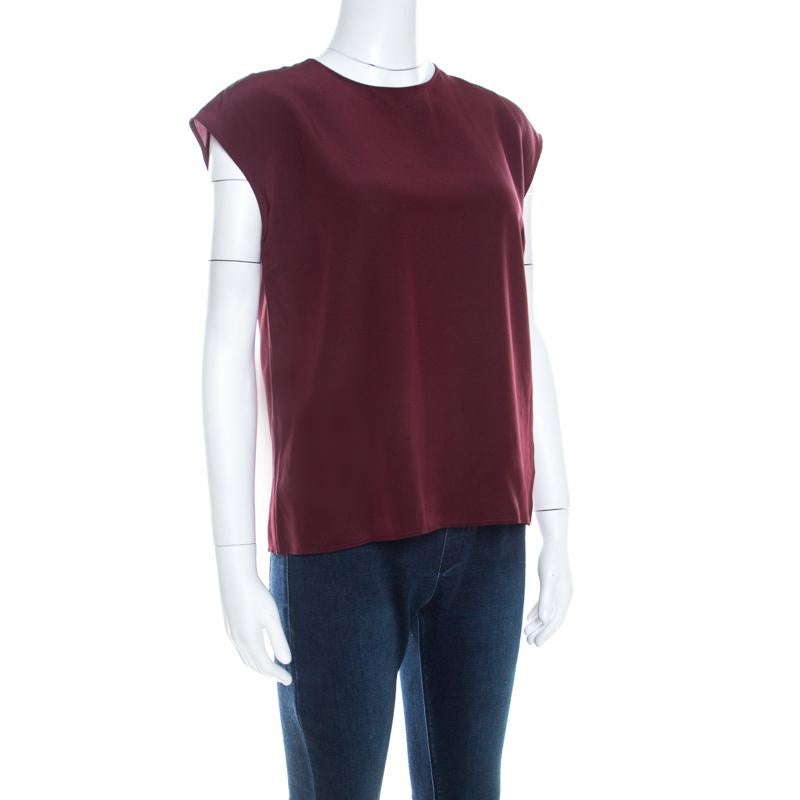 Pair this top from Dolce & Gabbana with your favorite accessories to create a classic style statement. Shade of burgundy combined with a simple design makes for this lovely top. This lovely 100% silk top is also high in comfort.

Includes: The