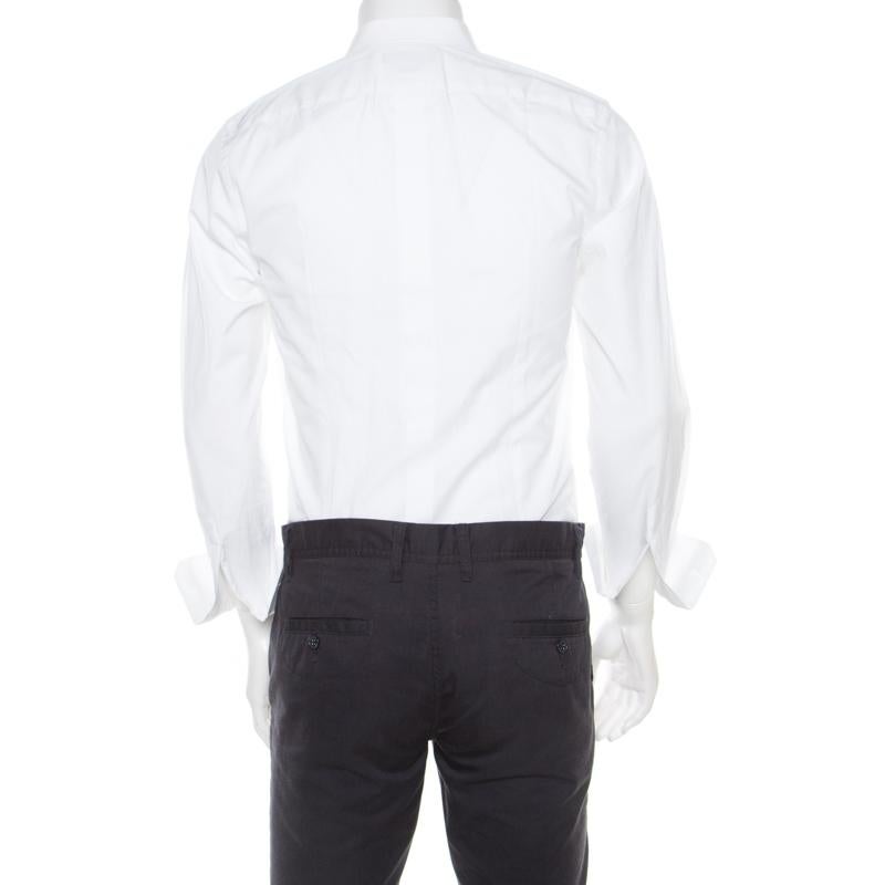 Sharp, neat and Dolce! Tailored wonderfully from cotton, this white shirt by Dolce & Gabbana will complement your tuxedos with class. It has been styled with a collar, front buttons, long sleeves, and textured bib detail.

Includes: The Luxury