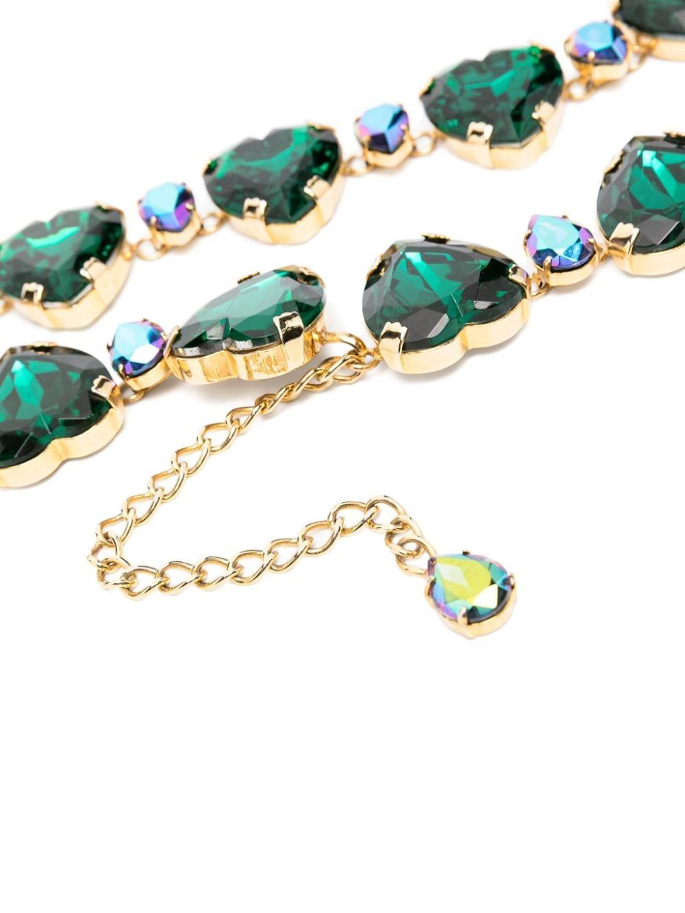 1990s Dolce and Gabbana green heart-charms chain belt featuring green glass crystal heats, gold-tone hardware, a gold-tone brand pitted hook, adjustable length. 
In good vintage condition. Made in Italy.
Maxi Length: 35in. (89 cm)
Heart maxi length: