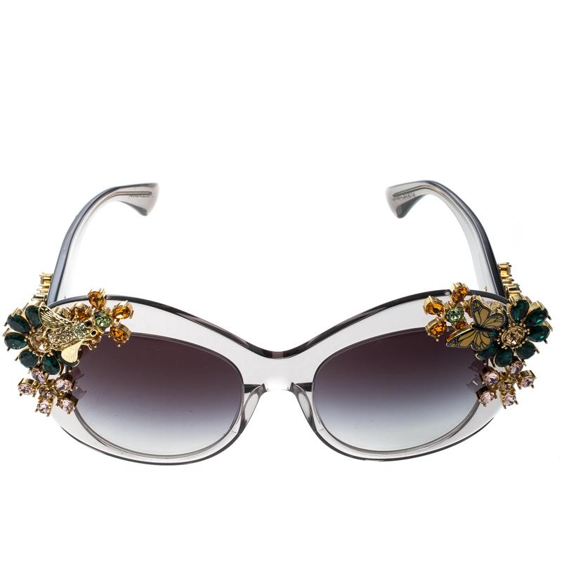 Accessories designed with an edge are just perfect to elevate one's unique style. These Dolce&Gabbana sunglasses are a fine example. The transparent frame is beautified with crystals in the pattern of flowers, and the grey lenses are fitted to keep