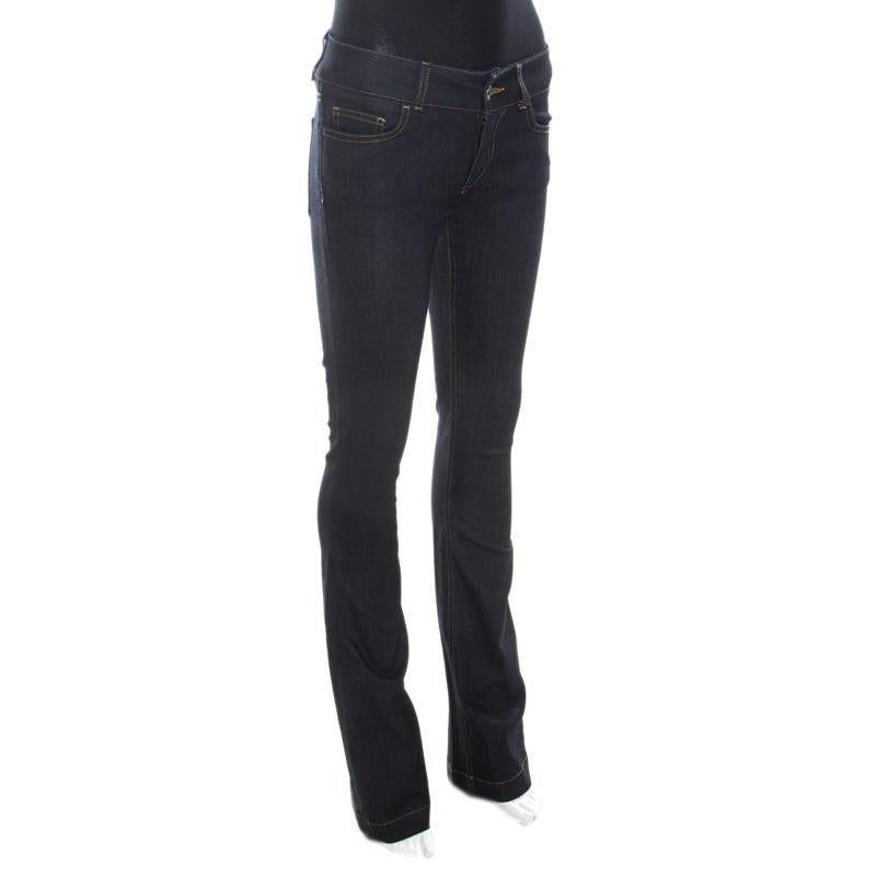 Ace the street-chic look with these indigo denims from the house of Dolce and Gabbana. This pair is designed in a flattering boot-cut pattern, with multiple pockets and the label’s initials embossed on the back pockets. It features a fly button