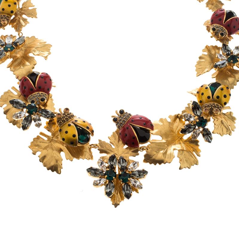 Designs by Dolce&Gabbana are not only well-made but are loaded with wonder and sweetness. This necklace, for example, is so unbelievably pretty. Made from gold-tone metal, the neckpiece has an assembly of leaves, crystals flowers and the most