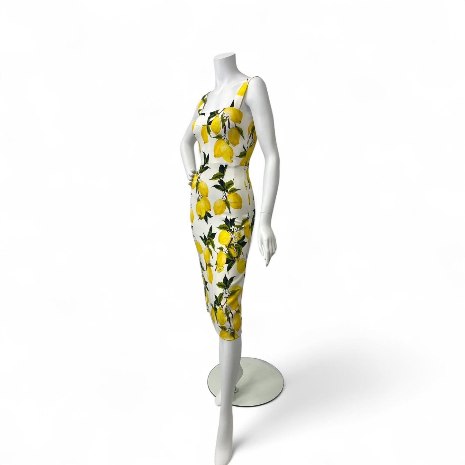 A signature of Dolce & Gabbana’s joyful Sicilian-inspired collections, this lemon print sleeveless midi sheath dress captures the brand’s celebration of vibrant color and feminine silhouettes.

Crafted in structured cotton-blend fabric, the dress