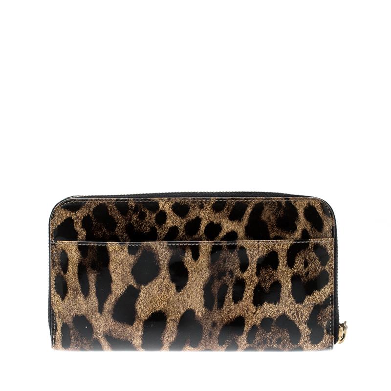 This wallet is crafted from a Dolce and Gabbana favourite, leopard print patent leather. A gold-tone zip opens the wallet to a leather and fabric-lined interior with a zip coin compartment and plenty of card slots. There is a wrist strap for the
