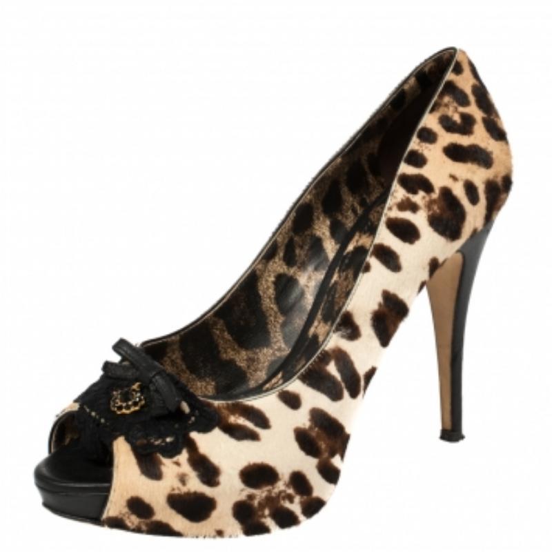 Upgrade your look by adding these Dolce & Gabbana pumps to your wardrobe. They are crafted from leopard printed pony hair and designed with peep toes, bows on the uppers, platforms, and 12 cm heels. Finesse and poise will all come naturally when you