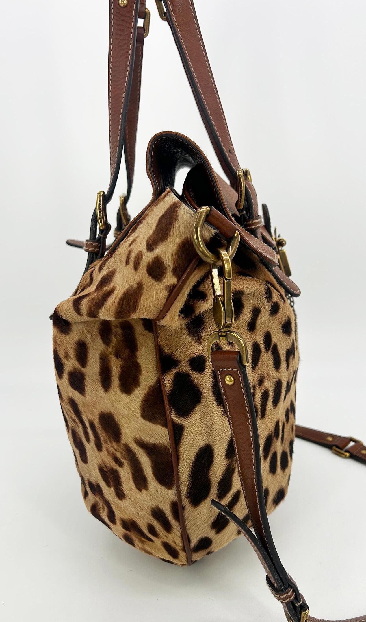Dolce and Gabbana Leopard Print Pony Hair Tan Leather Miss Privee Shoulder Bag in very good condition. Leopard print pony hair body trimmed with tan leather and brushed brass hardware. Adjustable top handles with 2 buckles on either strap.