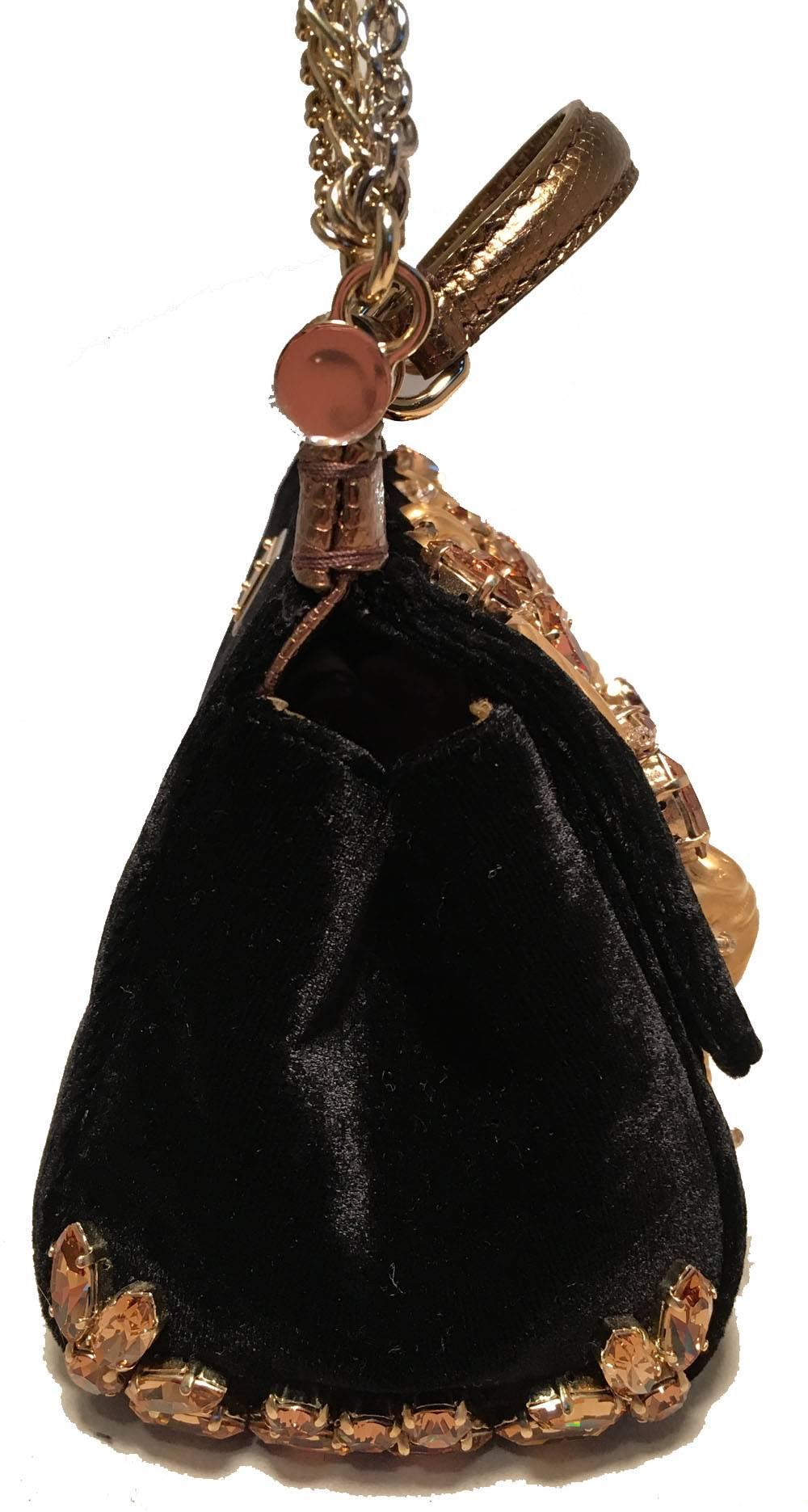 Absolutely stunning Dolce and Gabbana Limited Edition Black Velvet Alta Moda Sofia Sophia Loren Handbag in excellent condition.  Black velvet exterior trimmed with gold hardware and rhinestone embellishments throughout.  Lightweight multiple gold