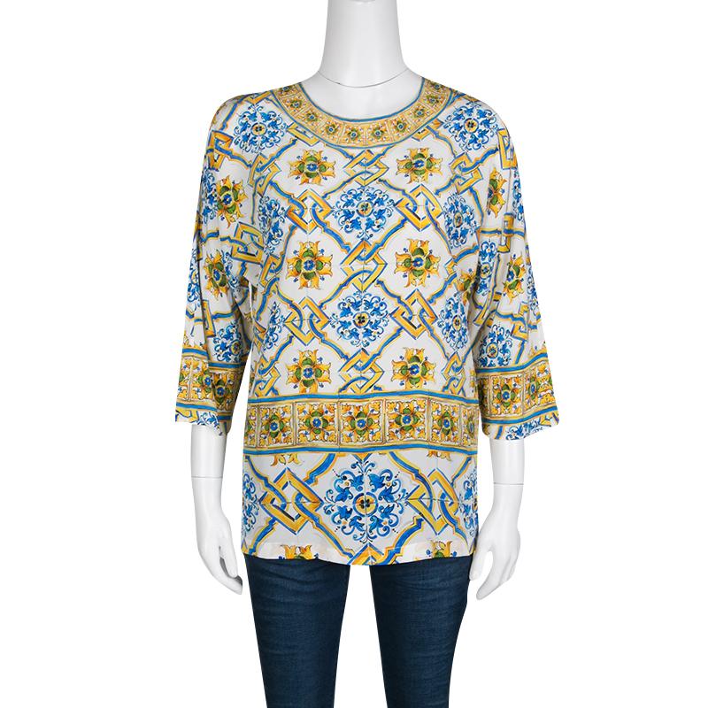 Dolce and Gabbana's top is a playful choice for your formal dos. It is crafted with silk featuring the Majolica print a testimony to the label's love for Scillian prints. It has dolman sleeves and a relaxed fit. Tuck it into your fitted pants for an