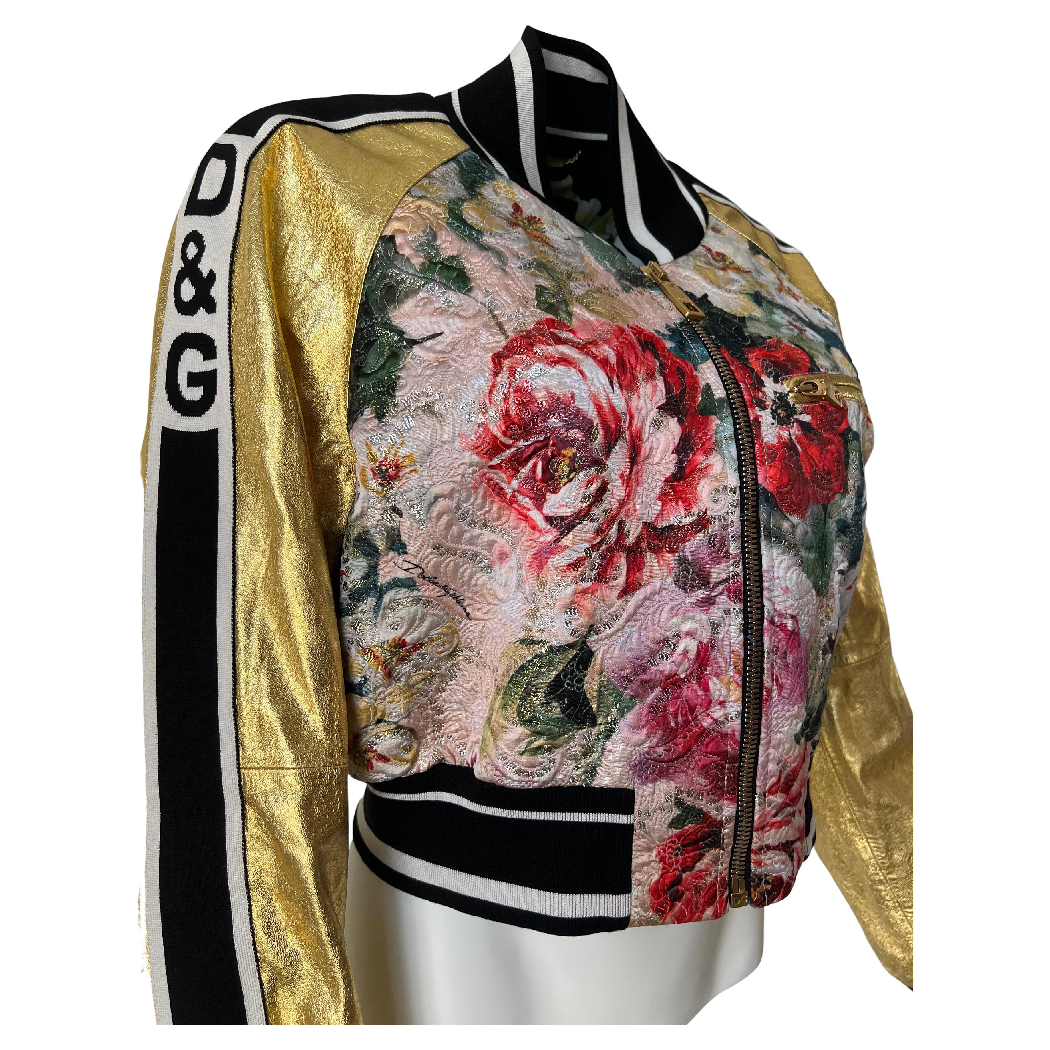 Beautiful cropped leather Dolce & Gabbana jacket. Floral lined with blue foiled leather. Outside is a beautiful semi foiled floral brocade with gold foiled leather sleeves and blue foil leather back. Detailed D&G zipper and piping. Made in Italy. 