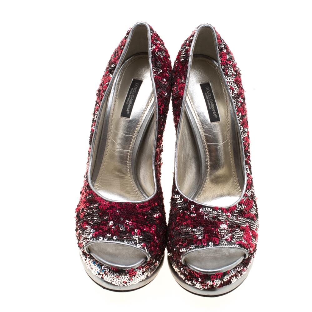 Shimmer and shine with these Dolce & Gabbana pumps. Covered with silver and red sequins, their exterior will add the right amount of glamour to any evening look. Their rounded toes are coupled with 15cm high heels and a leather outsole which joins