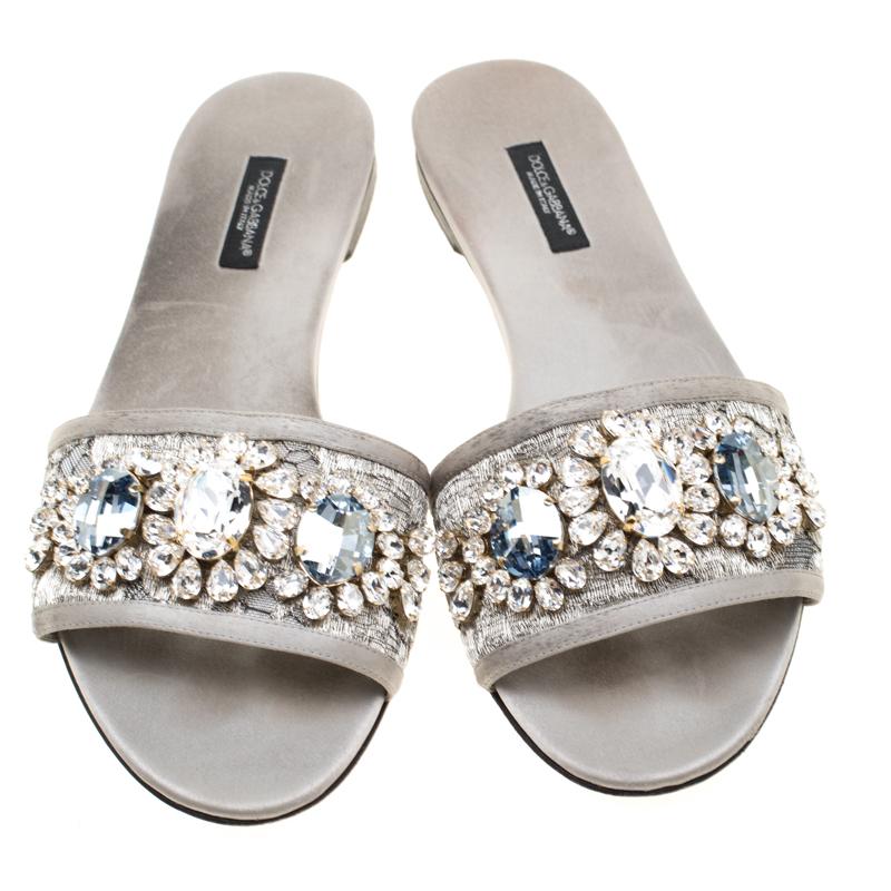 These Dolce and Gabbana slides are made with metallic lace with satin trims, while they are lined with mesh. What makes these slides so desirable is the breathtaking crystals embellishment on the vamps. This is definitely one pair that speaks beauty