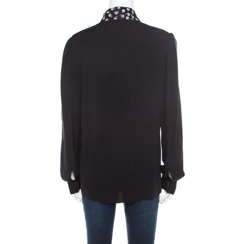 Dolce & Gabbana offers yet another fabulous design for fashionable women like you. This elegant black blouse has long sleeves and a contrast bib detailed with small flower prints and ruffles. Masterfully sewn, this blouse will make a fine