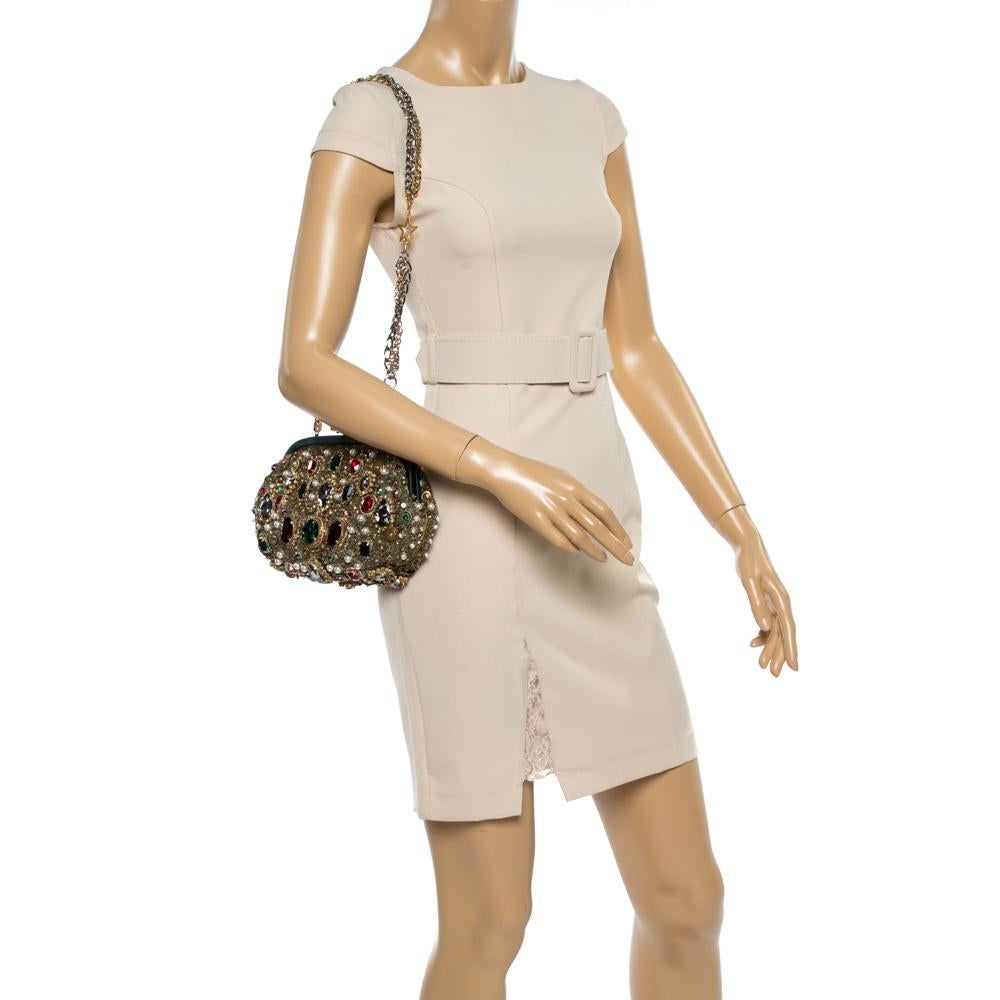 This exquisite frame clutch from Dolce and Gabbana will charm you with its striking details. The multicolor clutch is crafted from mesh and satin and adorned with breathtaking crystal, sequin, and pearl embellishments. On the top is a