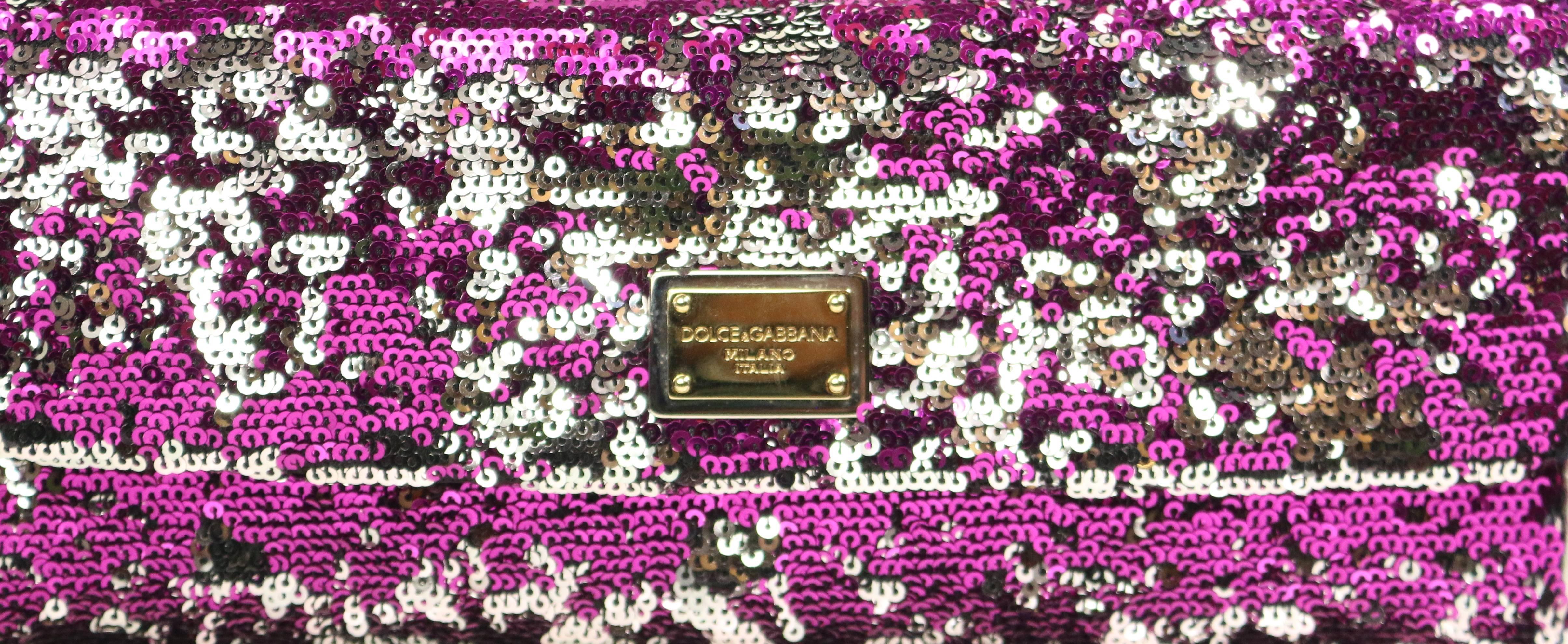 - Dolce and Gabbana pink/silver/black sequins shoulder bag. Featuring a silver, gold and black metal hardware chain strap, silver metallic leather trimming and inner flap with black satin interior and one small interior slip pocket. A magnetic