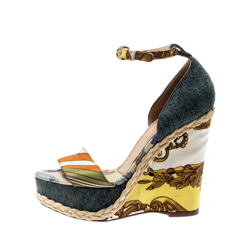 Keep your comfort at a maximum with these beautifully printed satin and denim sandals. Let these gorgeous sandals from Dolce & Gabbana, equipped with uber comfortable insoles and wedge heels, give you ease and style.

Includes: The Luxury Closet