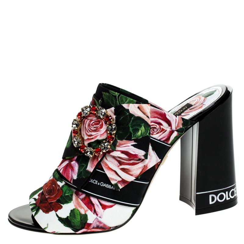 Bold, beautiful and breathtaking, these Dolce & Gabbana mules are made to enchant! They have been crafted from floral-printed fabric and flaunt open toes and bejeweled buckles on the uppers. Comfortable leather-lined insoles and 10 cm block heels