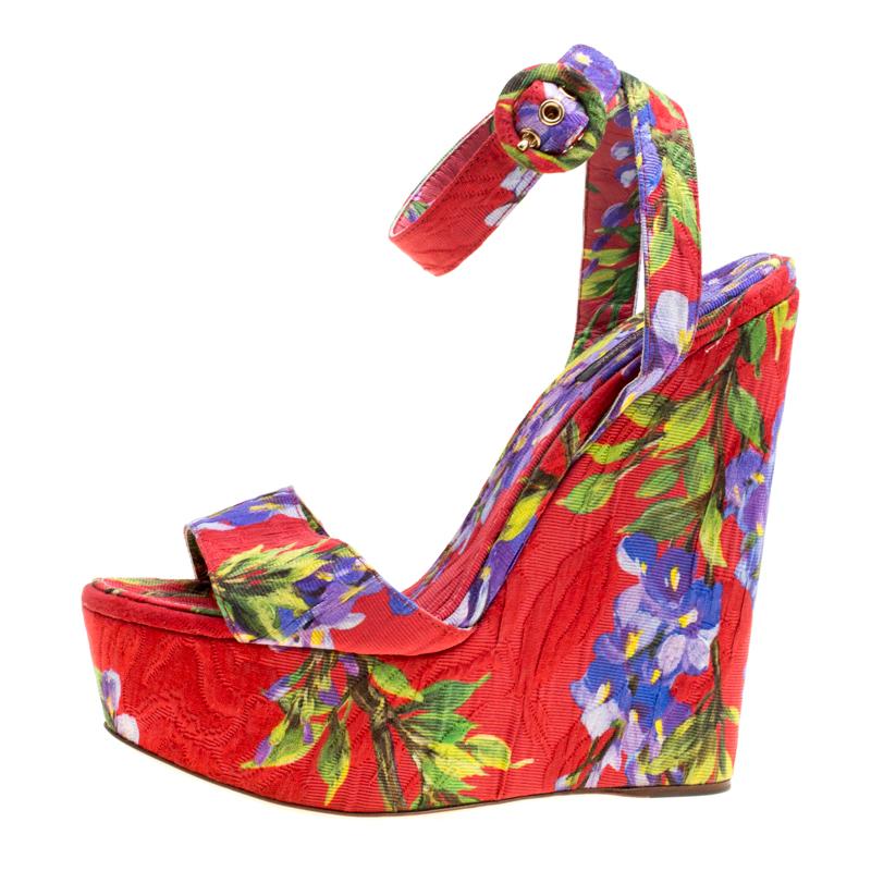 We adore this pair of sandals from Dolce and Gabbana from their shape to their overall appeal. Beautifully crafted from fabric in a burst of floral prints the sandals feature peep toes, ankle straps and are elevated on 16 cm wedges. They are easy to