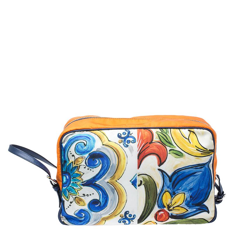 This bag from the house of Dolce & Gabbana has been expertly crafted from quality nylon and secured with top-zip closure. The exterior features a lovely multicolored print that adds interest. It comes with a nylon interior equipped with side