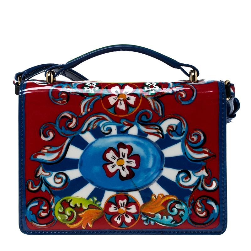 Dolce & Gabbana brings us this gorgeous Rosalia bag that has been crafted from printed patent leather and designed with a twist lock on the flap that secures a suede interior. The piece is complete with a shoulder strap and will enhance all your