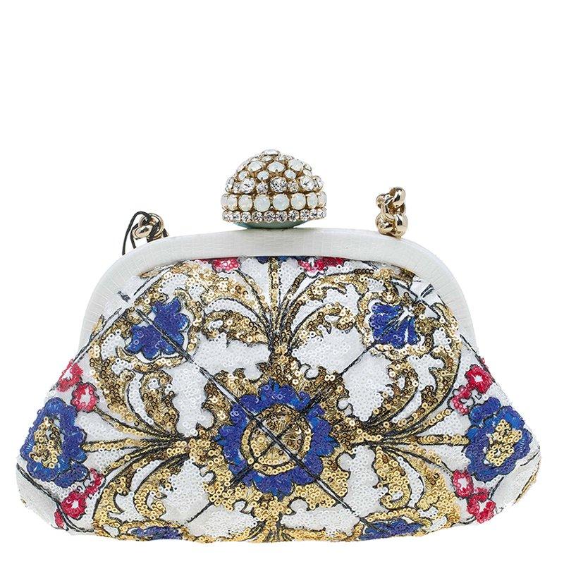 Look dazzling with this Dolce and Gabbana Clutch on your arm. Meticulously made from sequins, this one of a kind clutch sets the stage for a beautiful studded embellishment. The top closure opens up to reveal a satin lined interior with a patch