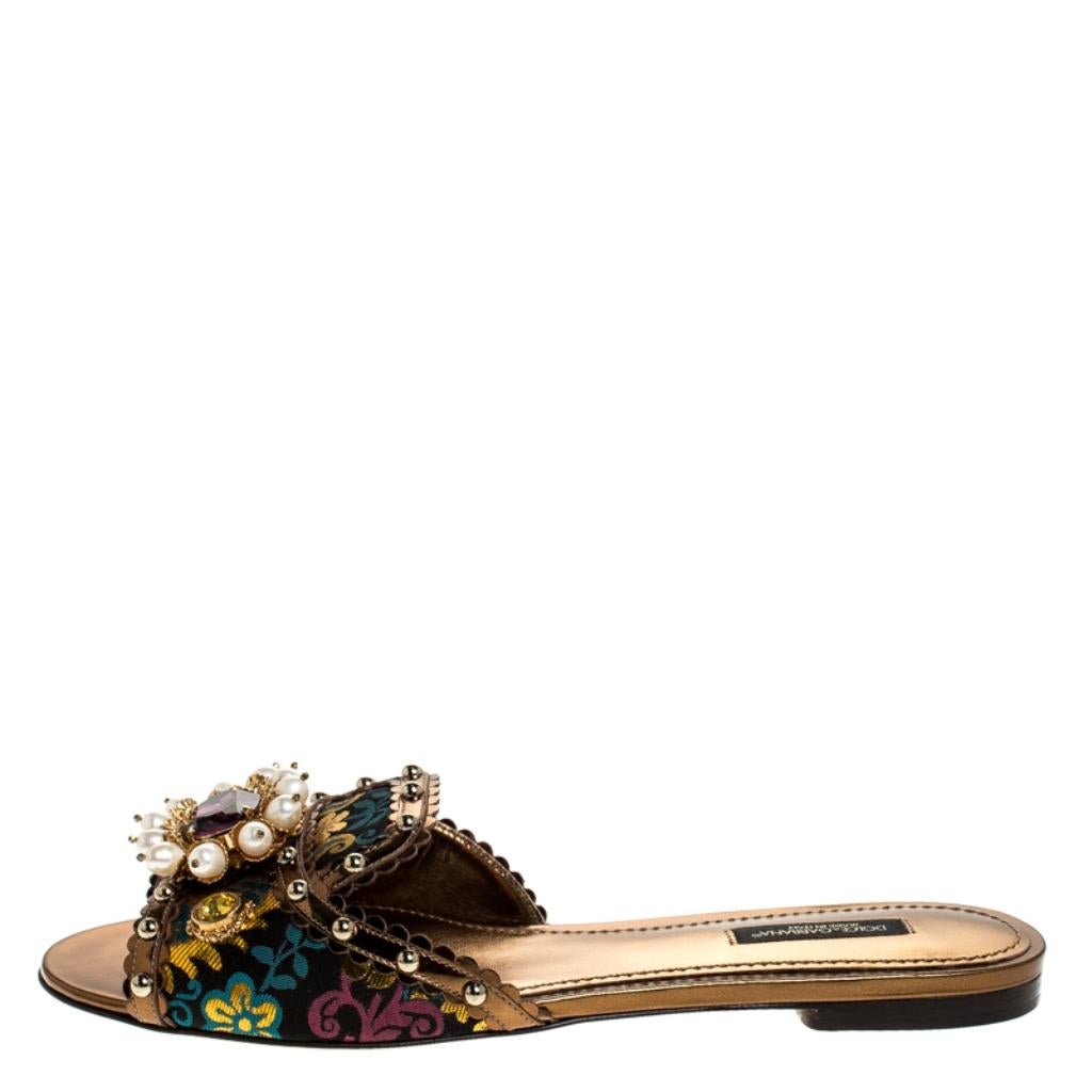 We can't stop gushing over these stunning flat slides from Dolce & Gabbana. They flaunt such exquisite details, like the grand embellishments over floral brocade fabric, the open toes and the leather lining. You will truly love to own these