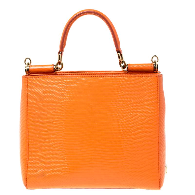This gorgeous orange Miss Sicily satchel from Dolce & Gabbana is a handbag coveted by women around the world. It has a well-structured design and two fabric-lined compartments with enough space to fit your essentials. The bag comes with gold-tone