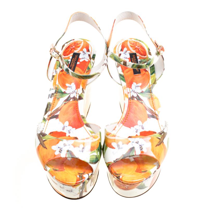 These Dolce and Gabbana sandals are so pretty, they make our hearts flutter with joy. Made in Italy, this pair has a patent leather exterior printed with oranges, and ankle straps with side buckle fastening. The sandals are complete with wedge heels