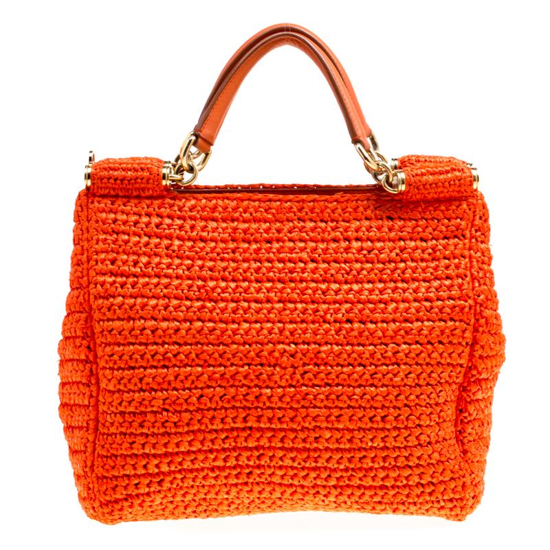 Beautiful with intricate details, this orange Miss Sicily bag by Dolce & Gabbana will get you through all seasons. The exterior is made from woven raffia and the bag features two handles and a spacious fabric interior.

Includes: The Luxury Closet