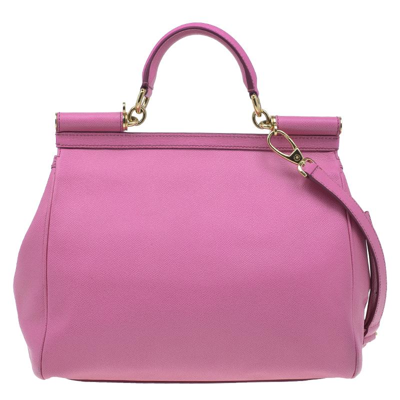 Belonging to the adorable Miss Sicily collection, this Dolce and Gabbana tote is the perfect bag to be carried for special outings. Its embossed pink leather exterior is combined with gold-tone hardware. It has a flap opening with a logo plaque, a