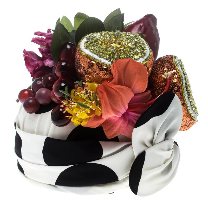 Designs by Dolce&Gabbana are not only well-made but are loaded with wonder and sweetness. This turban, for example, is so unbelievably pretty. It is made from stretch silk of polka dots and crowned with an assembly of leaves, flowers and fruits. We