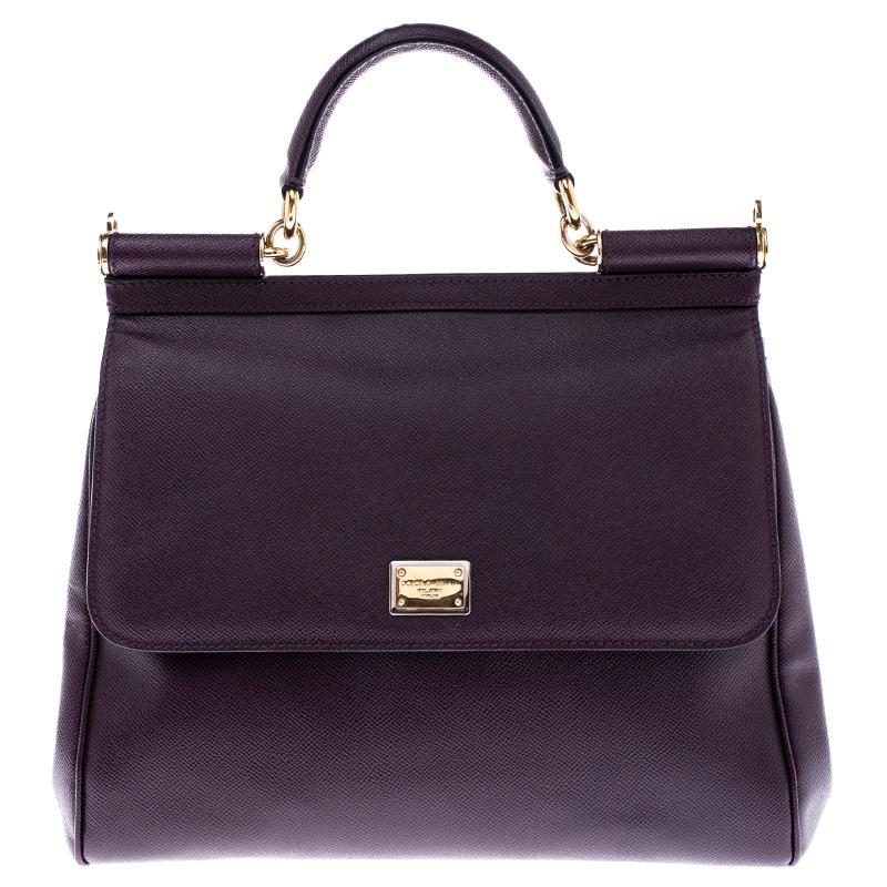 This gorgeous purple Miss Sicily satchel from Dolce & Gabbana is a handbag coveted by women around the world. It has a well-structured design and a flap that opens to a compartment with fabric lining and enough space to fit your essentials. The bag