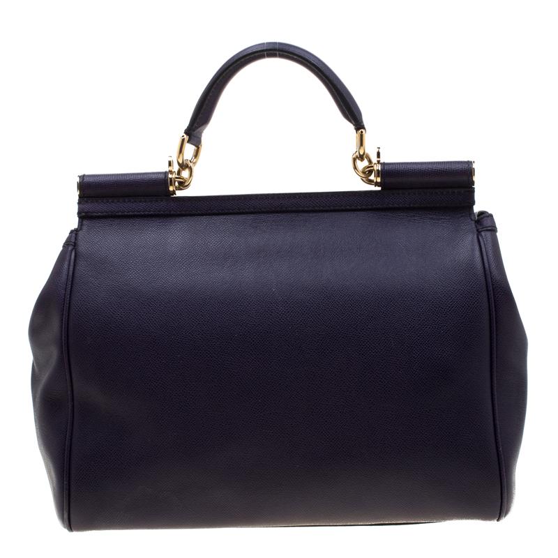 This gorgeous purple Miss Sicily tote from Dolce & Gabbana is a bag coveted by women around the world. It has a well-structured design and a flap that opens to a compartment with fabric lining and enough space to fit your essentials. It comes with