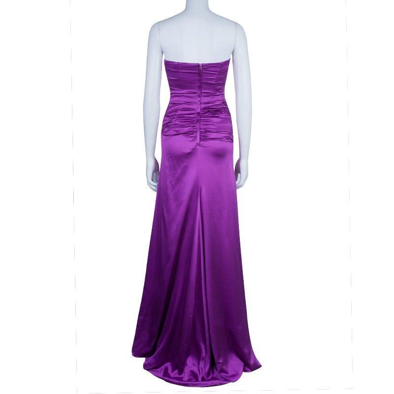 This flattering purple silk gown by Dolce and Gabbana displays the label's regal predilections. With supportive ruching at the bodice, this floor-sweeping design is kept in place with a concealed back zipper and features a soft sweet heart neckline.