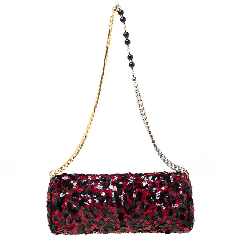 Stylish and handy, Miss Charles shoulder bag from Dolce and Gabbana is crafted from red/black sequin. The bag comes with a chain link handle and a spacious satin lined interior that houses a slip pocket. Sophisticated and stylish this bag is the